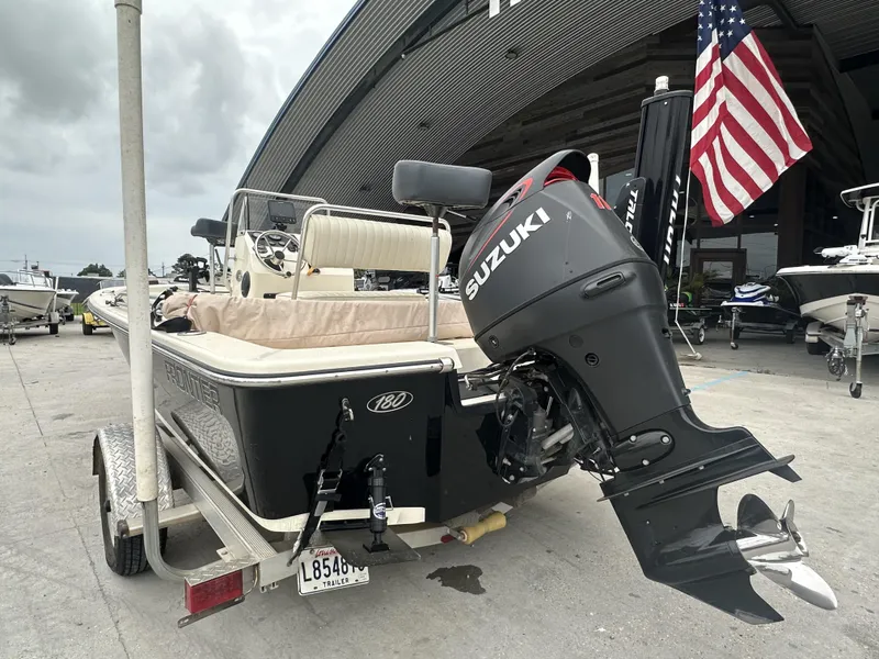Slide: The Image of 2016 Frontier 180 CC boat with Suzuki outboard motor on trailer. - 3