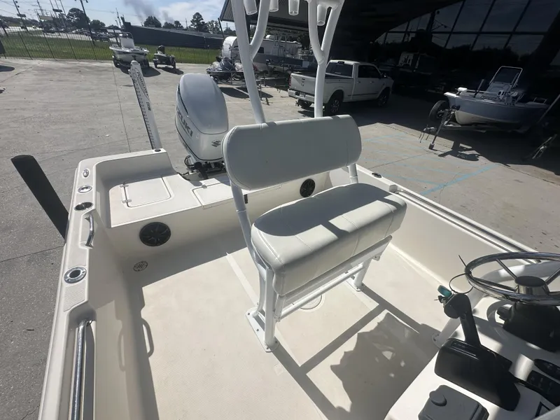 Slide: The Image of 2021 Bulls Bay 2400 boat interior with seating and Suzuki outboard motor. - 21