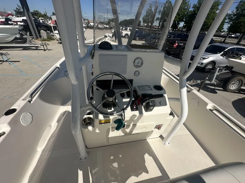 Slide: The Image of 2021 Bulls Bay 2400 boat cockpit with steering wheel and control panel. - 3