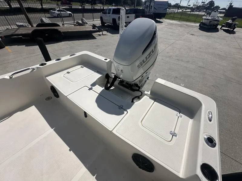 Slide: The Image of 2021 Bulls Bay 2400 boat with Suzuki outboard motor in a parking lot. - 9