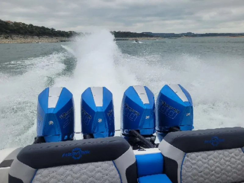 Slide: The Image of 2024 Fountain 38 SCX boat with four powerful outboard engines on the water. - 12