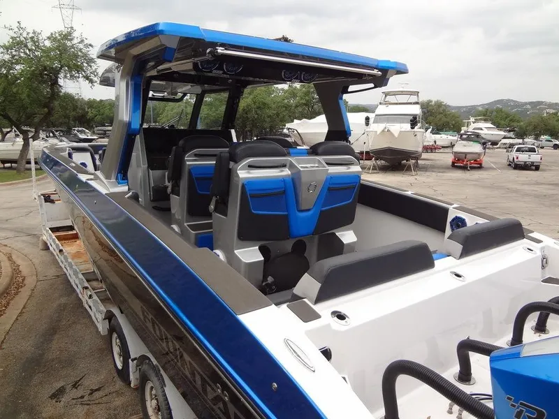 Slide: The Image of 2024 Fountain 38 SCX boat with blue and black exterior, docked on a trailer. - 13