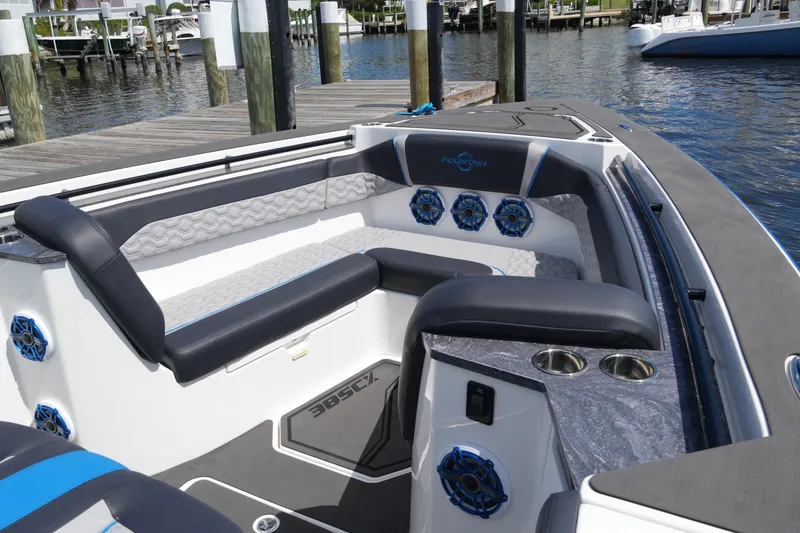 Slide: The Image of 2024 Fountain 38 SCX boat interior with luxurious seating and modern design at a dock. - 25