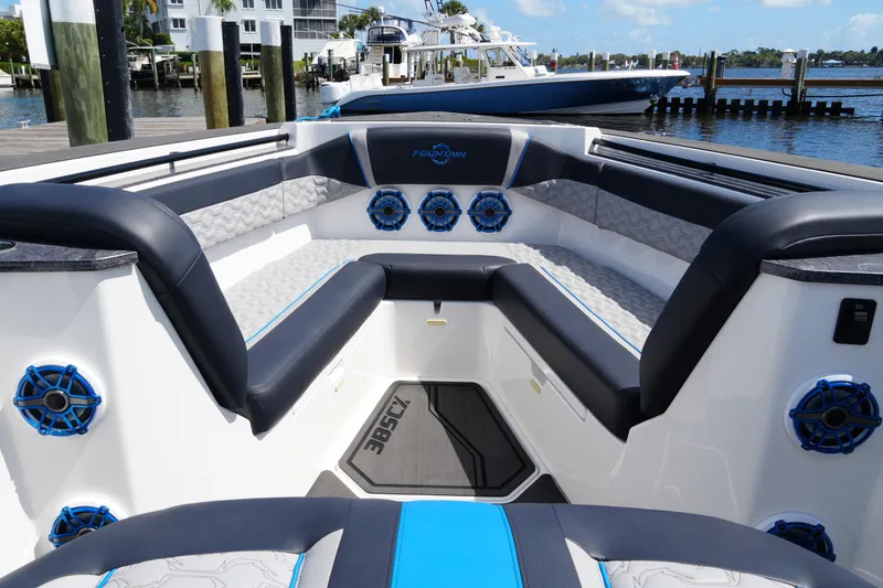 Slide: The Image of 2024 Fountain 38 SCX boat interior with blue accents and waterfront view. - 27