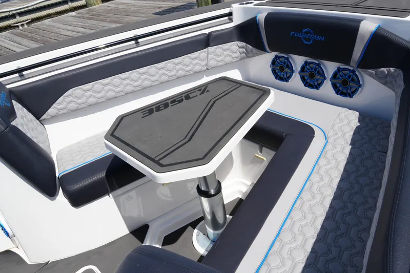 Slide: The Image of 2024 Fountain 38 SCX boat interior with seating and table, featuring stylish design and speakers. - 29