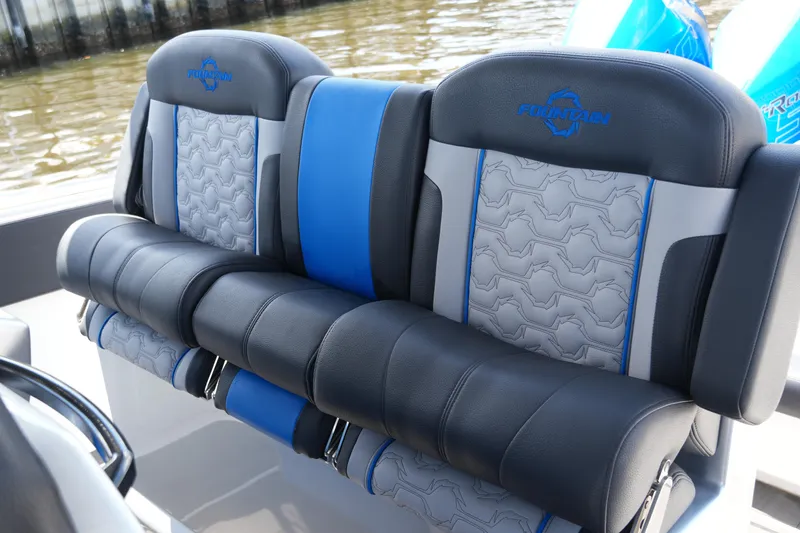 Slide: The Image of 2024 Fountain 38 SCX boat seats with blue and gray upholstery, featuring logo embroidery. - 46