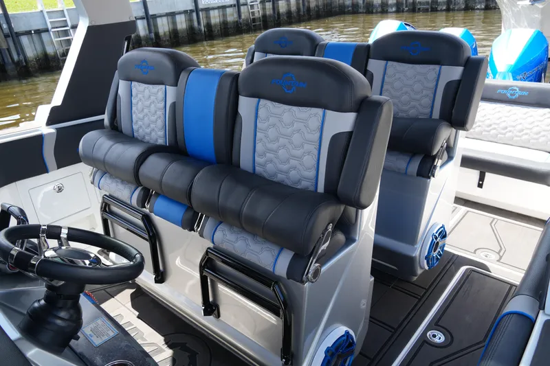 Slide: The Image of 2024 Fountain 38 SCX boat interior with luxurious seating and modern steering wheel. - 48