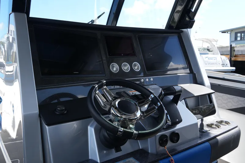 Slide: The Image of 2024 Fountain 38 SCX boat dashboard with steering wheel and digital displays. - 49