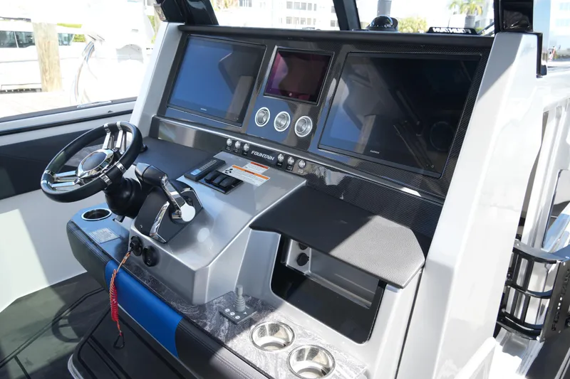 Slide: The Image of 2024 Fountain 38 SCX boat dashboard with modern controls and navigation screens. - 50