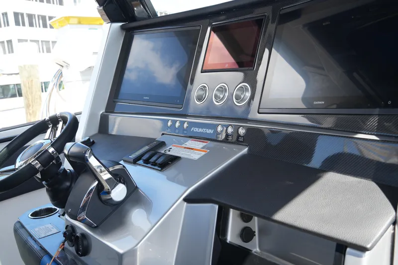 Slide: The Image of 2024 Fountain 38 SCX boat dashboard with modern controls and navigation screens. - 53