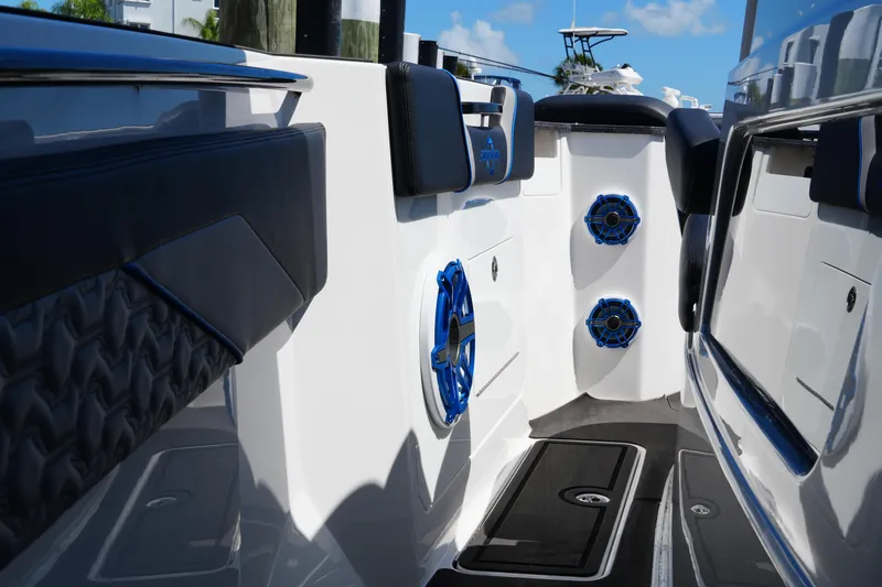 Slide: The Image of 2024 Fountain 38 SCX boat interior with blue speakers and sleek seating design. - 58