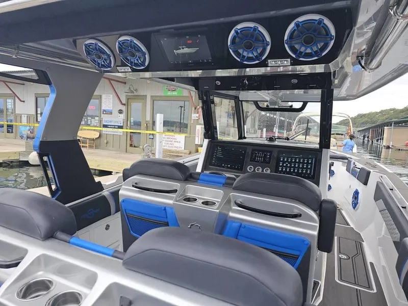 Slide: The Image of 2024 Fountain 38 SCX boat interior with advanced dashboard and seating. - 6