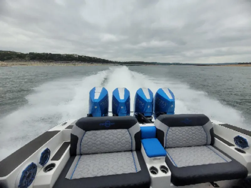 Slide: The Image of 2024 Fountain 38 SCX speedboat with quad engines cruising on open water. - 8