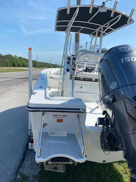 Slide: The Image of 2024 Parker 18SE Center Console boat with Yamaha 150 engine, docked on a sunny day. - 3