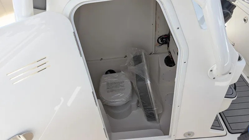 Slide: The Image of 2025 Key West 291 FS boat interior with compact marine toilet. - 14