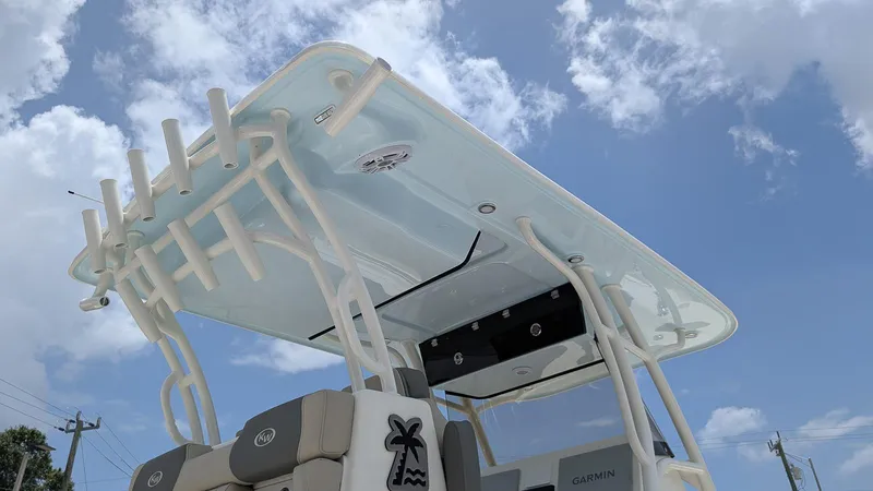 Slide: The Image of 2025 Key West 291 FS boat with T-top under a clear blue sky. - 21