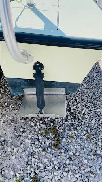 Slide: The Image of 1983 Maverick 18 Flats Boat stern detail on gravel surface. - 11