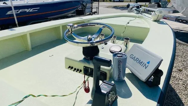 Slide: The Image of 1983 Maverick 18 Flats Boat with Garmin navigation system and steering wheel. - 7
