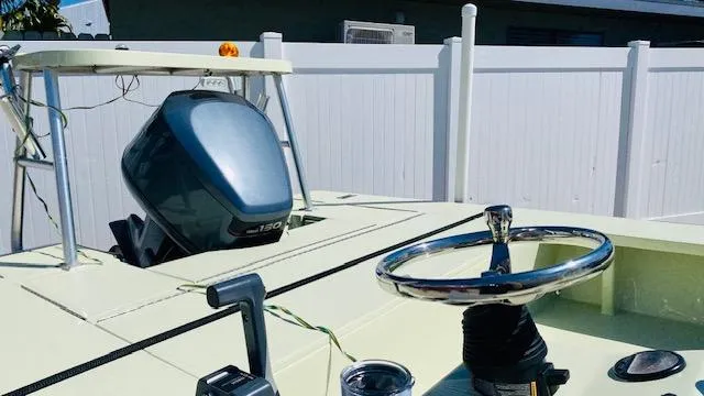 Slide: The Image of 1983 Maverick 18 Flats Boat with outboard motor and steering wheel. - 8