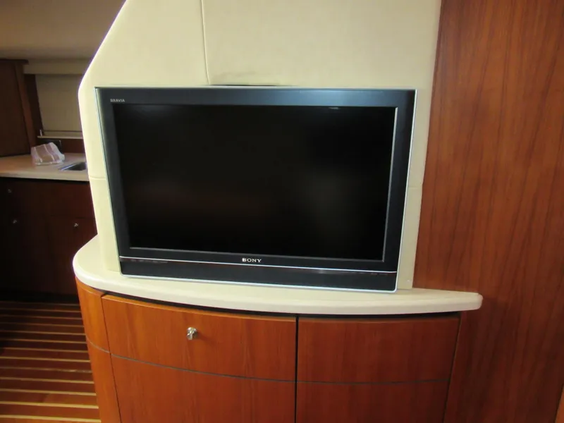 Slide: The Image of 2006 Tiara Yachts 4300 Sovran interior with Sony TV and wooden cabinetry. - 12