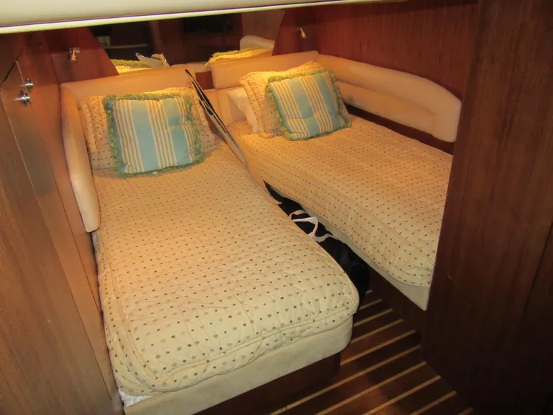 Slide: The Image of 2006 Tiara Yachts 4300 Sovran cabin with twin beds and striped pillows. - 20