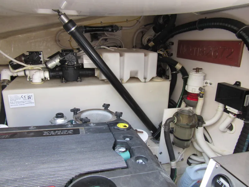 Slide: The Image of Engine compartment of a 2006 Tiara Yachts 4300 Sovran, showcasing mechanical components and wiring. - 22