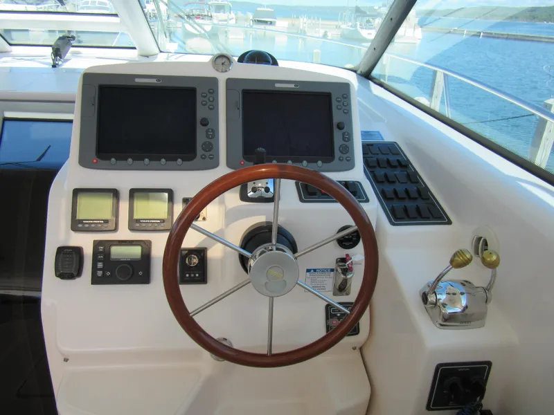 Slide: The Image of Helm of 2006 Tiara Yachts 4300 Sovran with dual displays and wooden steering wheel. - 3