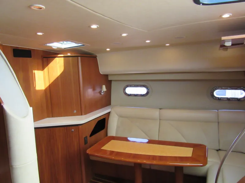Slide: The Image of 2006 Tiara Yachts 4300 Sovran interior with elegant seating and wooden table. - 9
