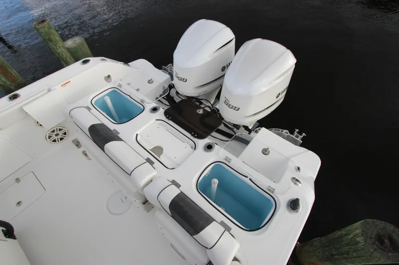 Slide: The Image of 2020 Wellcraft 302 Fisherman boat with dual outboard engines and fishing amenities. - 12
