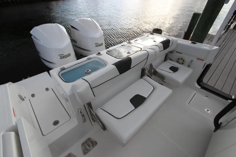 Slide: The Image of 2020 Wellcraft 302 Fisherman boat with twin 300 horsepower engines, docked by the water. - 14