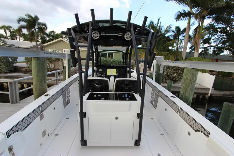 Slide: The Image of 2020 Wellcraft 302 Fisherman boat with center console and fishing rod holders. - 16