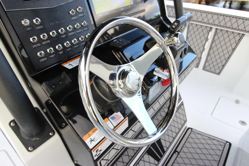Slide: The Image of 2020 Wellcraft 302 Fisherman boat steering wheel and control panel. - 24