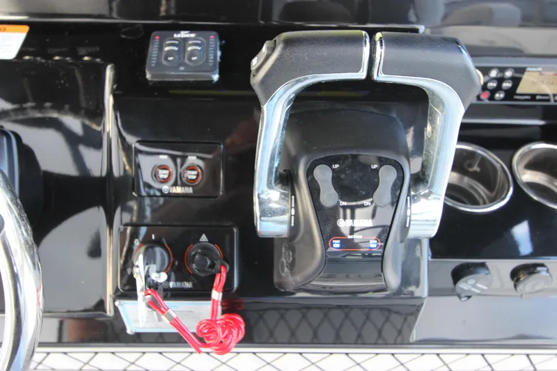 Slide: The Image of Control panel of a 2020 Wellcraft 302 Fisherman boat with throttle and switches. - 25