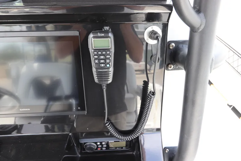 Slide: The Image of Control panel of a 2020 Wellcraft 302 Fisherman boat with radio and display. - 31