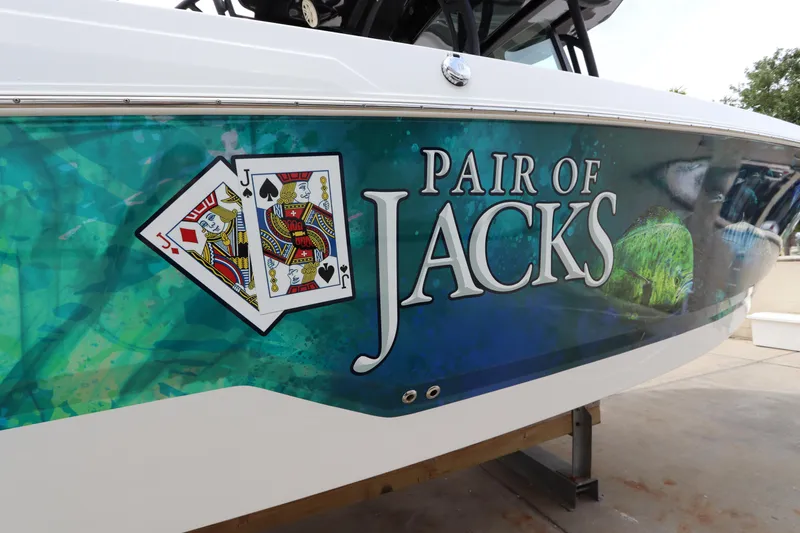 Slide: The Image of 2020 Wellcraft 302 Fisherman boat with Pair of Jacks graphic and playing cards design. - 4