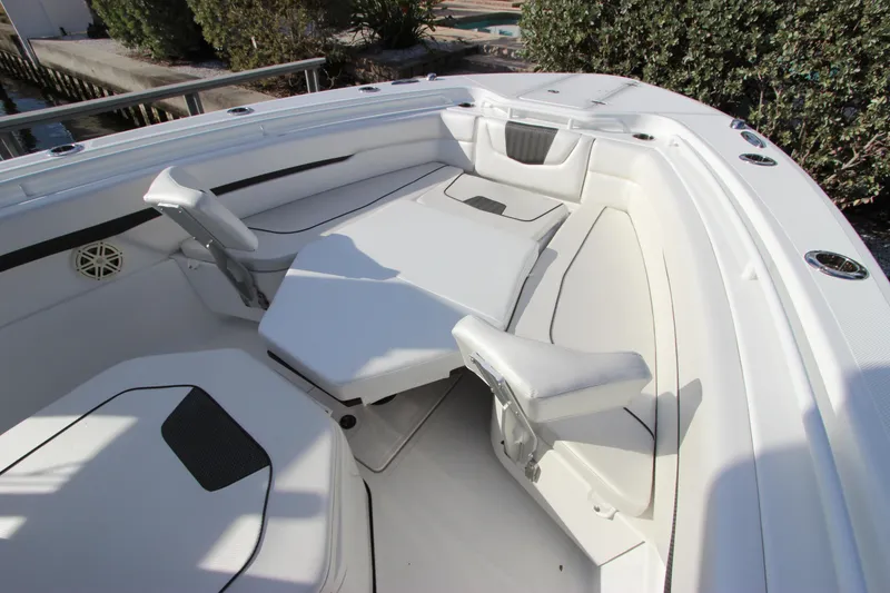 Slide: The Image of 2020 Wellcraft 302 Fisherman boat interior with white seating and adjustable table. - 40