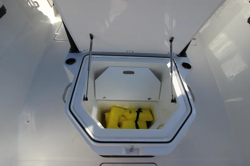 Slide: The Image of Open storage compartment on a 2020 Wellcraft 302 Fisherman boat with yellow life jackets. - 46