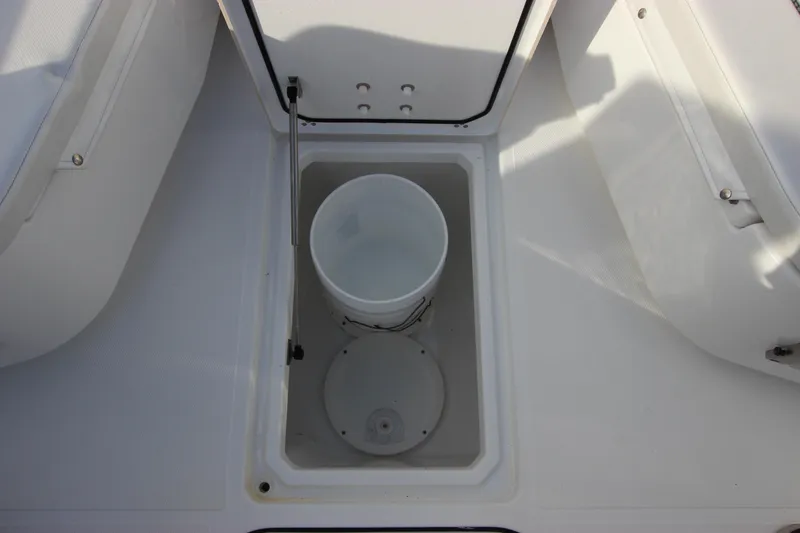 Slide: The Image of Wellcraft 302 Fisherman 2020 boat storage compartment with bucket. - 47