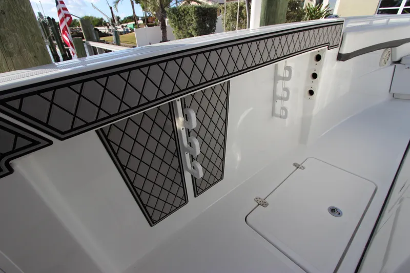 Slide: The Image of 2020 Wellcraft 302 Fisherman boat interior with rod holders and storage compartments. - 49