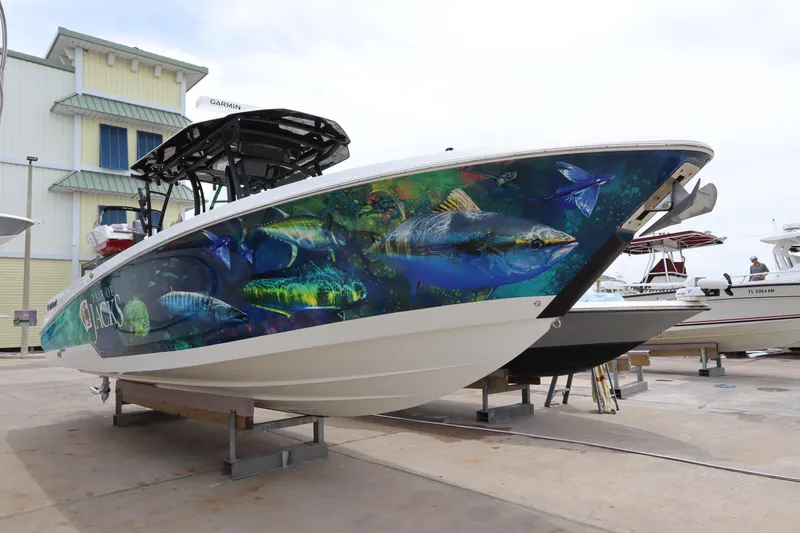 Slide: The Image of 2020 Wellcraft 302 Fisherman boat with vibrant fish-themed hull wrap. - 7
