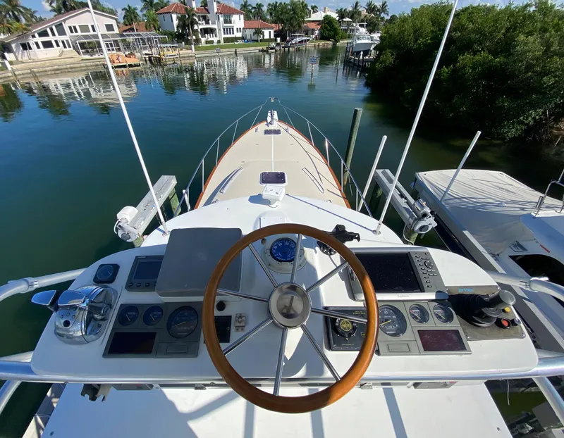 Slide: The Image of Helm of 2000 Little Harbor 42 Whisper Jet yacht docked in a serene marina. - 14