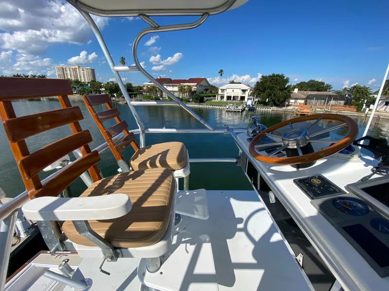 Slide: The Image of Little Harbor 42 Whisper Jet 2000 helm station with wooden seats and steering wheel. - 15