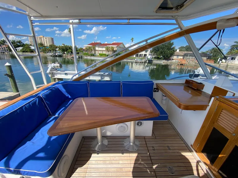 Slide: The Image of Little Harbor 42 Whisper Jet 2000 yacht with blue seating and wooden table on deck. - 21
