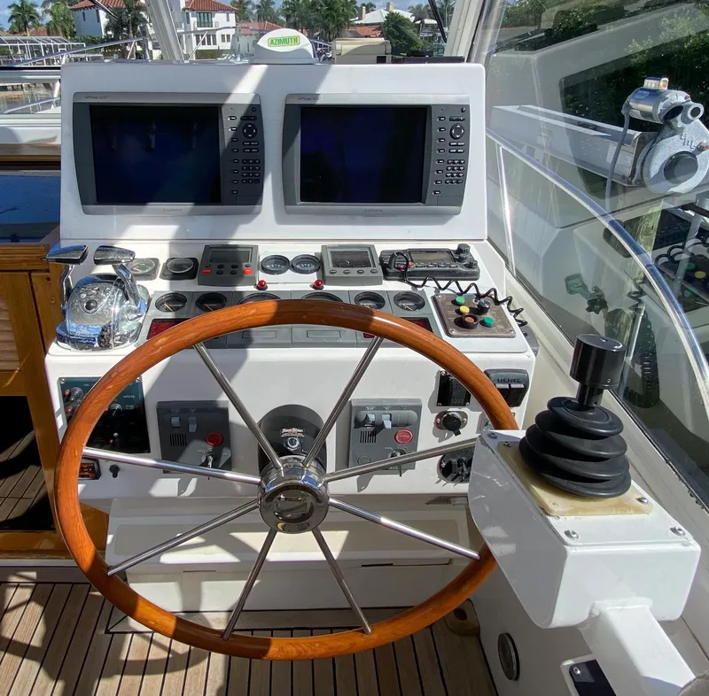 Slide: The Image of Helm station of a 2000 Little Harbor 42 Whisper Jet with wooden steering wheel and navigation equipment. - 26
