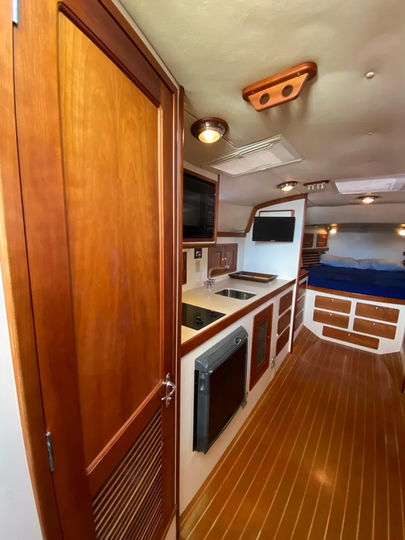 Slide: The Image of Interior of 2000 Little Harbor 42 Whisper Jet with wooden cabinetry and compact kitchen. - 29