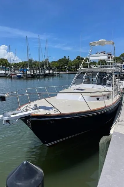 Slide: The Image of 2000 Little Harbor 42 Whisper Jet docked at a marina on a sunny day. - 3