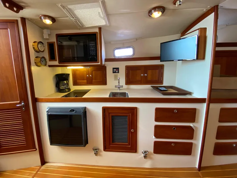 Slide: The Image of 2000 Little Harbor 42 Whisper Jet yacht kitchen with modern amenities and wooden cabinetry. - 30
