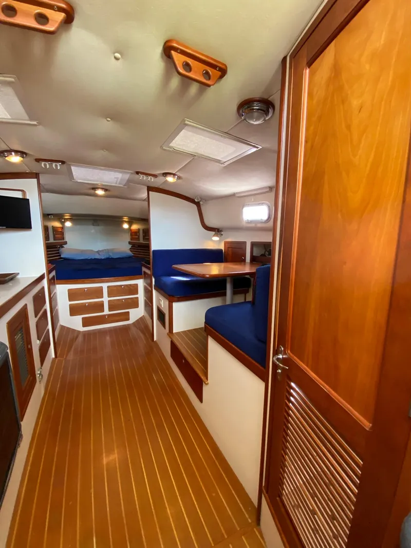 Slide: The Image of Interior of 2000 Little Harbor 42 Whisper Jet with wood finishes and blue seating. - 31