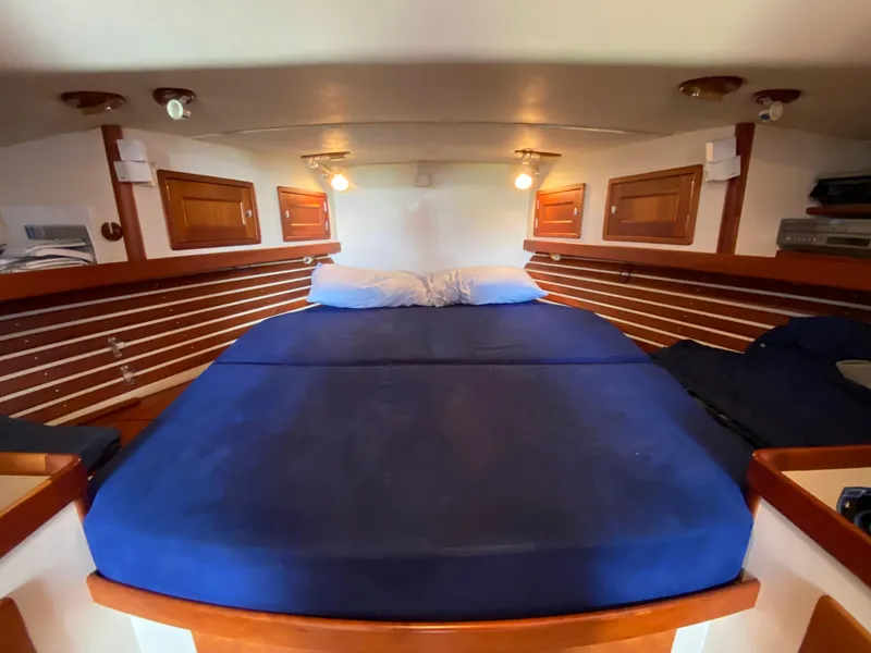 Slide: The Image of Cozy cabin interior of 2000 Little Harbor 42 Whisper Jet with blue bedding. - 33