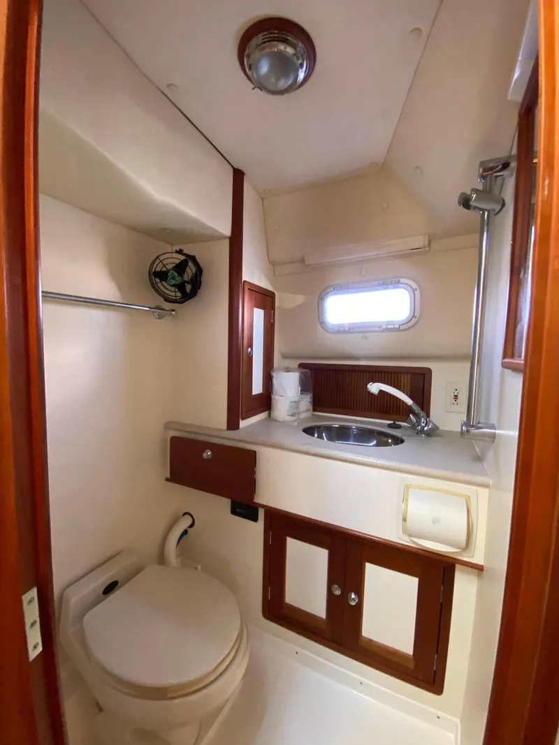 Slide: The Image of 2000 Little Harbor 42 Whisper Jet bathroom with sink, toilet, and storage cabinets. - 36